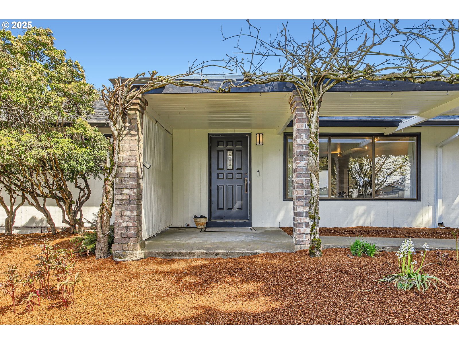 6121 Southwest Wilbard Street Portland, OR 97219 - Photo 3 of 28 a front view of a house with garden