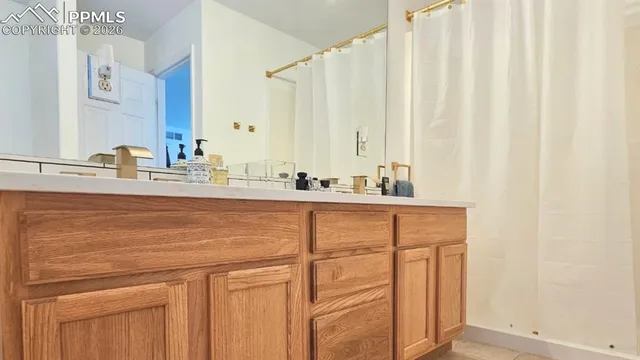 a view of a patio with chairs and potted plants