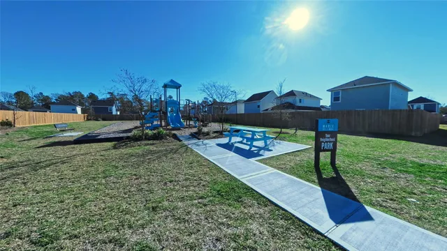 a view of a yard with wooden fence