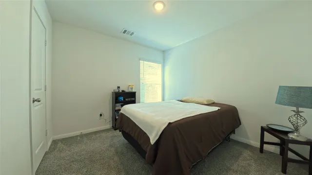 a bedroom with a bed and window