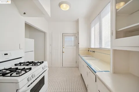 a kitchen with a refrigerator sink stove and cabinets