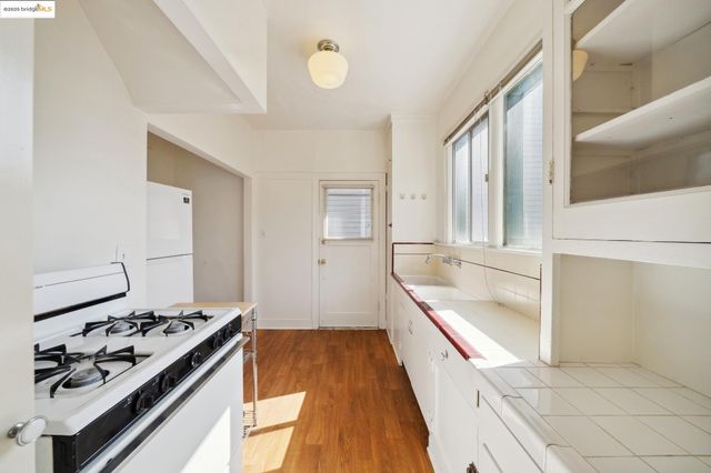 a kitchen with granite countertop a refrigerator and a stove