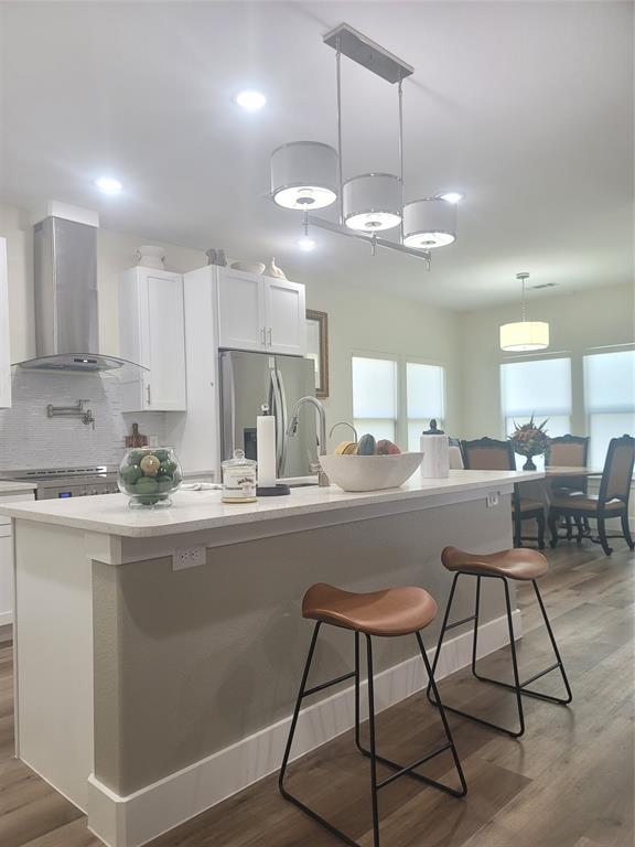 4825 Wichita Street Granbury, TX 76048 - Photo 10 of 30 a kitchen with stainless steel appliances granite countertop a sink a stove a refrigerator and island with wooden floor