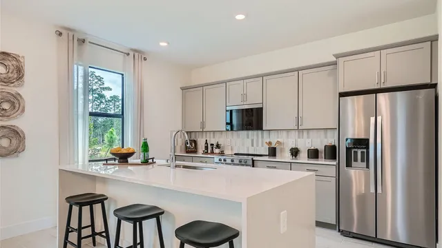 a kitchen with appliances a sink and cabinets