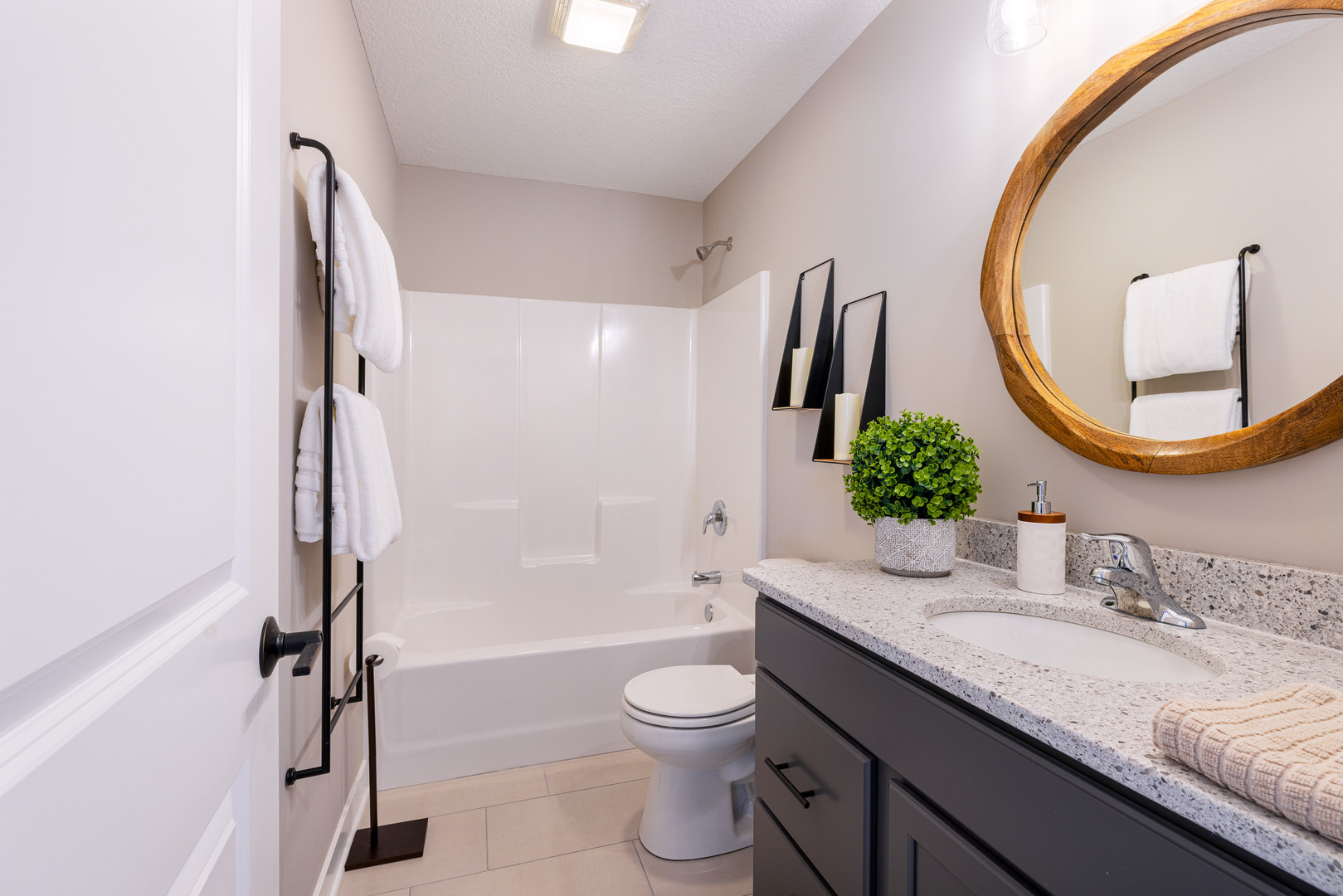 2-17 7th Street Silvis, IL 61282 - Photo 23 of 29 a bathroom with a granite countertop sink toilet a mirror and bathtub