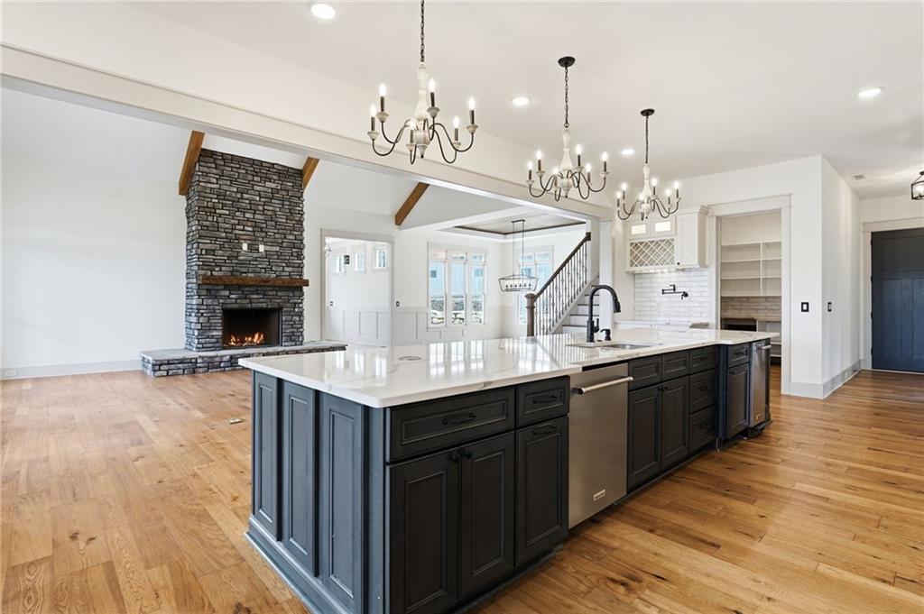 738 Overlook Trail Acworth, GA 30101 - Photo 22 of 94 a large kitchen with granite countertop a large island in the center and stainless steel appliances