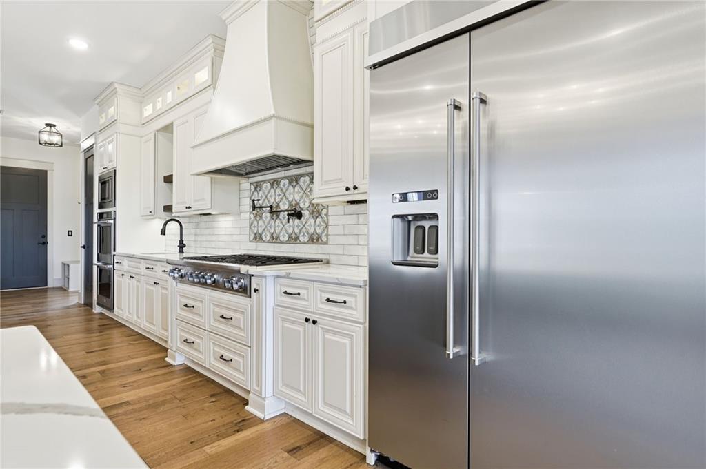 738 Overlook Trail Acworth, GA 30101 - Photo 23 of 94 a kitchen with stainless steel appliances a refrigerator sink and stove