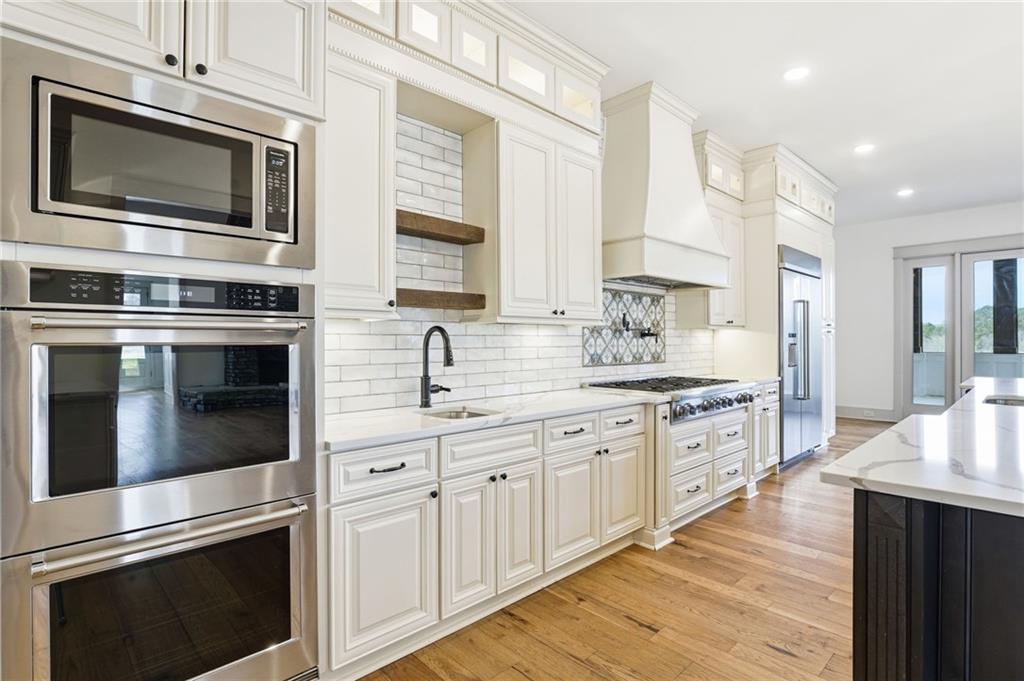 738 Overlook Trail Acworth, GA 30101 - Photo 24 of 94 a kitchen with stainless steel appliances granite countertop a stove microwave and sink