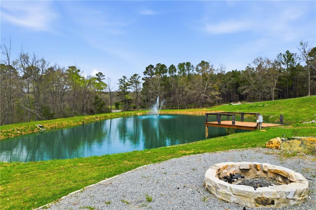 738 Overlook Trail Acworth, GA 30101 - Photo 4 of 94 a view of a lake with a house in the background