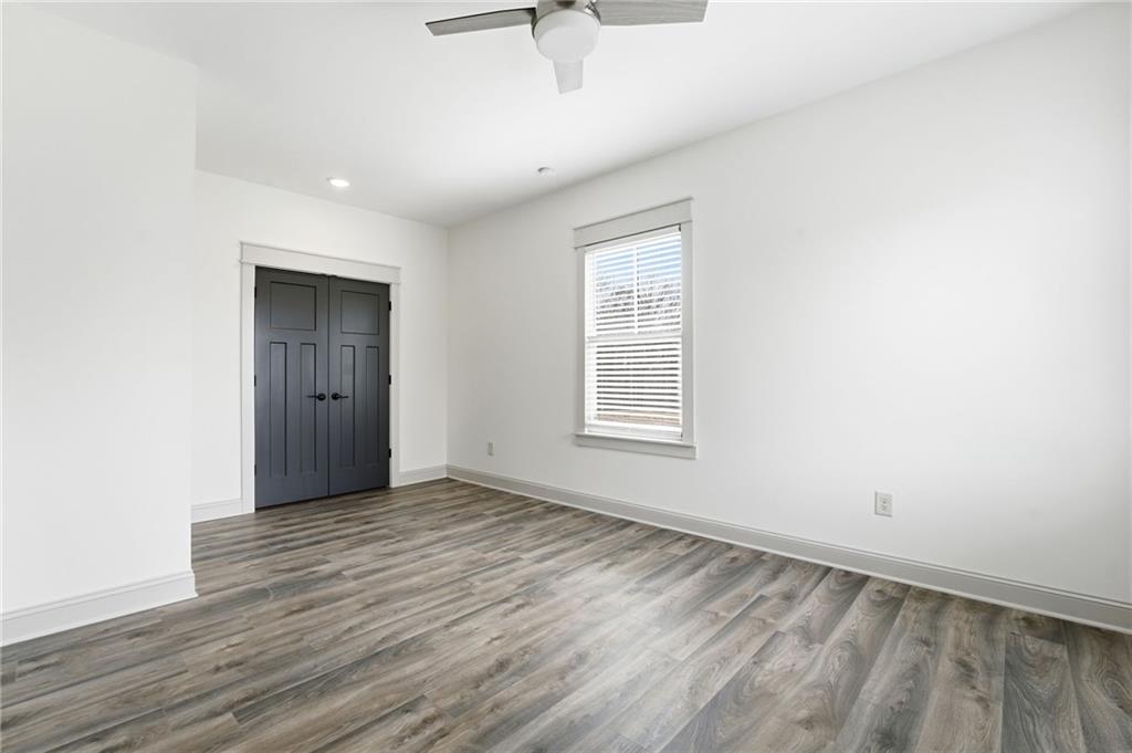 738 Overlook Trail Acworth, GA 30101 - Photo 59 of 94 an empty room with wooden floor cabinet and windows