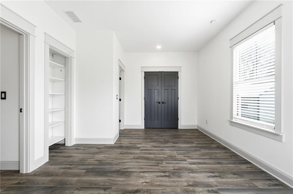 738 Overlook Trail Acworth, GA 30101 - Photo 60 of 94 a view of an empty room with wooden floor and a window