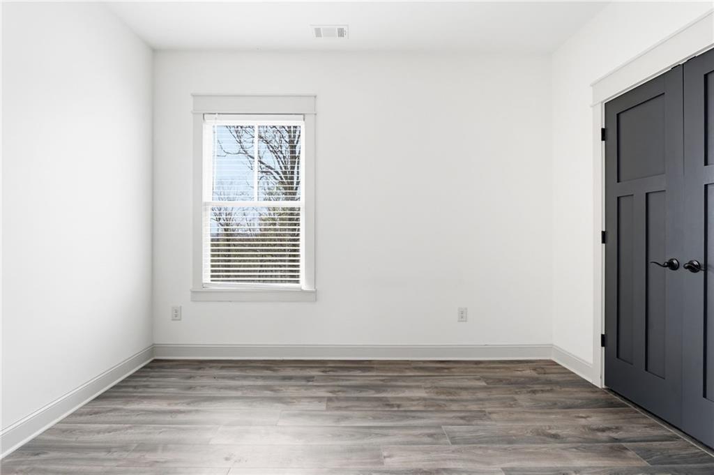 738 Overlook Trail Acworth, GA 30101 - Photo 61 of 94 a view of an empty room with wooden floor and a window
