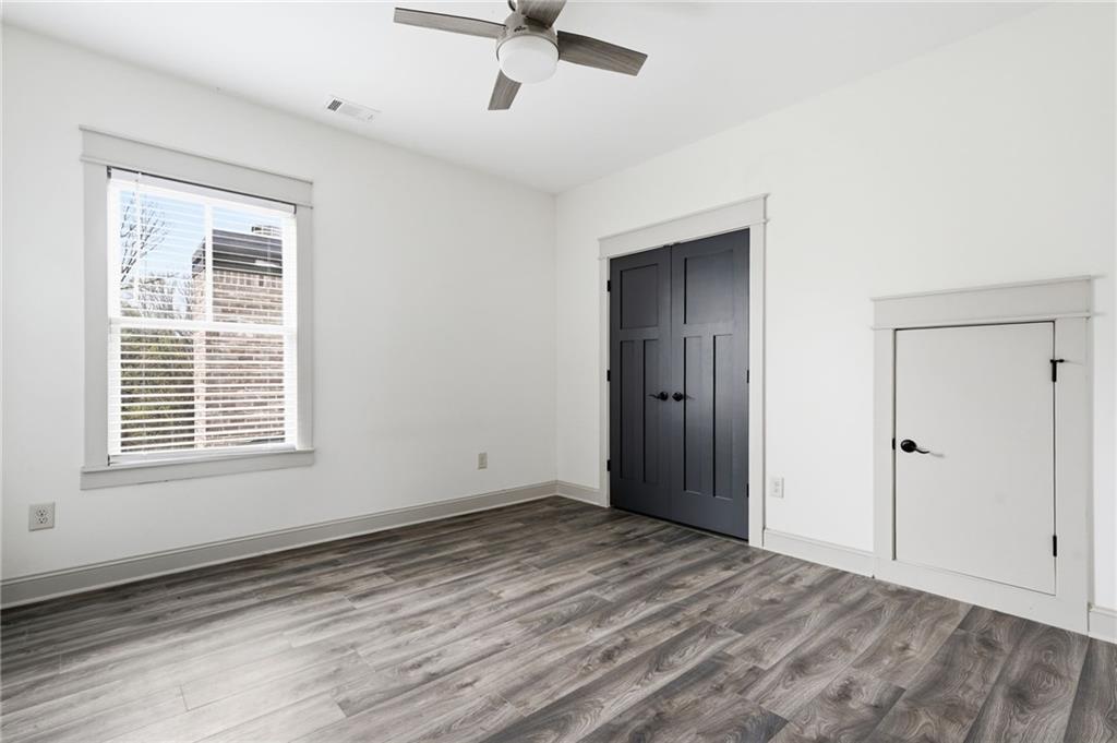738 Overlook Trail Acworth, GA 30101 - Photo 62 of 94 a view of an empty room with wooden floor and a window