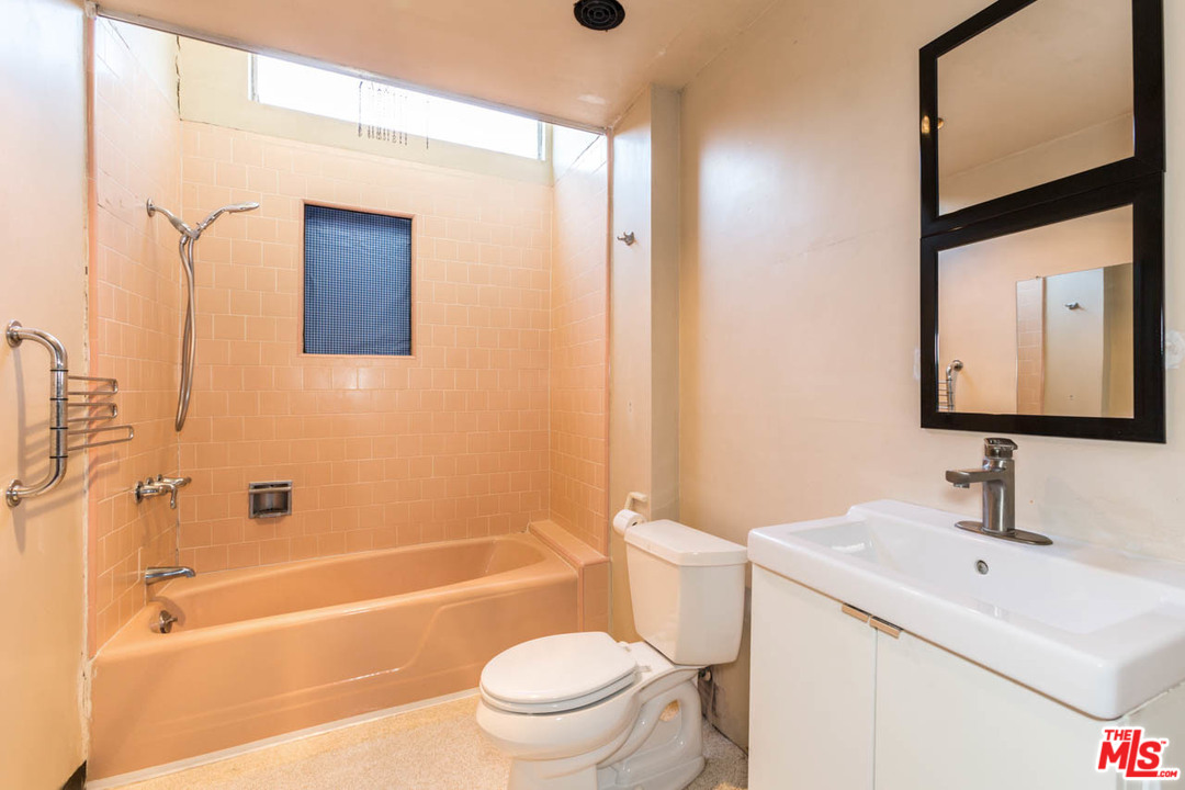 2300 Edgewater Terrace Los Angeles, CA 90039 - Photo 26 of 39 a bathroom with a toilet sink vanity tub and mirror