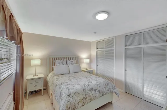 a bedroom with a bed and a night stand