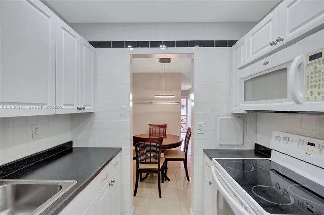 a kitchen that has a sink and a stove in it