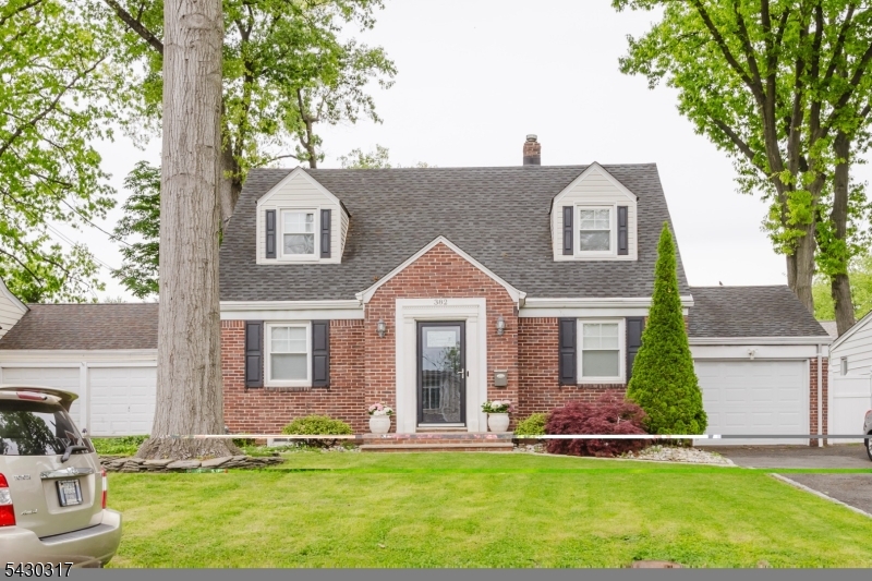 382 Martin Road Union, NJ 07083 - Photo 1 of 30 a front view of a house with a yard and garage
