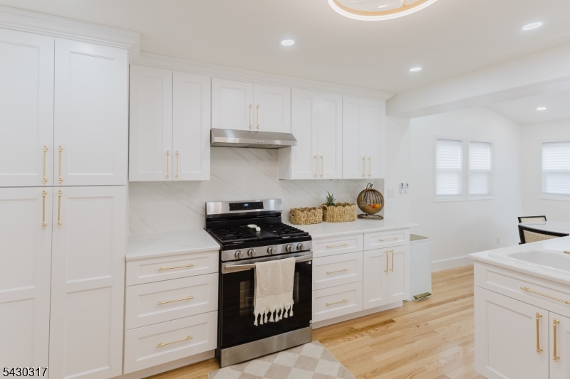382 Martin Road Union, NJ 07083 - Photo 11 of 30 a kitchen with stainless steel appliances granite countertop a stove and a white cabinets