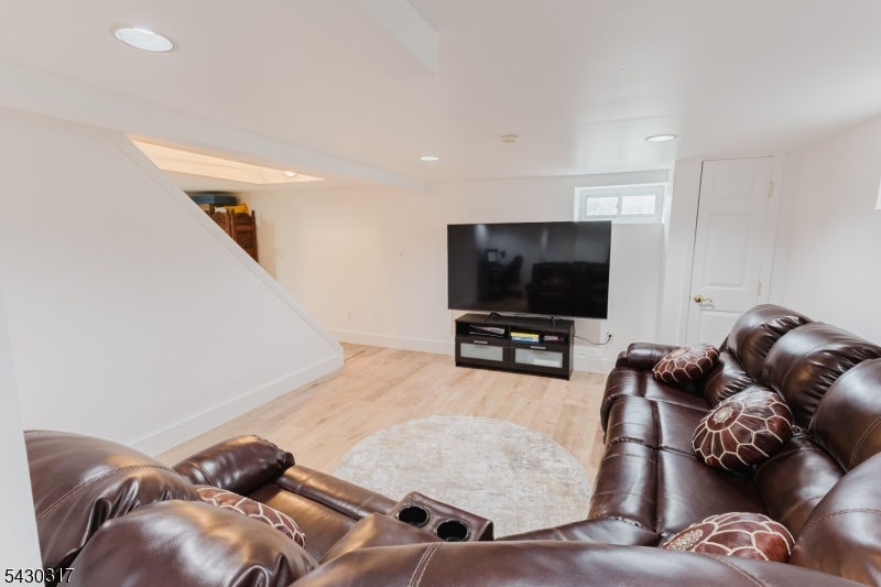 382 Martin Road Union, NJ 07083 - Photo 24 of 30 a living room with furniture and a flat screen tv