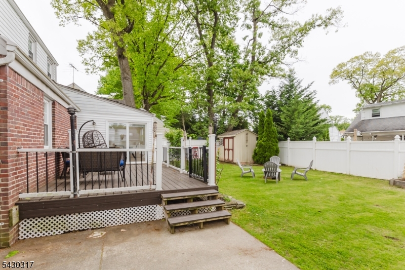 382 Martin Road Union, NJ 07083 - Photo 30 of 30 a view of a patio with a table and chairs and wooden fence