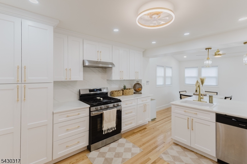 382 Martin Road Union, NJ 07083 - Photo 10 of 30 a kitchen with white cabinets and appliances
