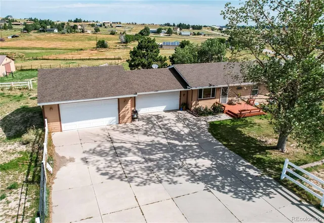 an aerial view of residential houses with outdoor space and ocean view