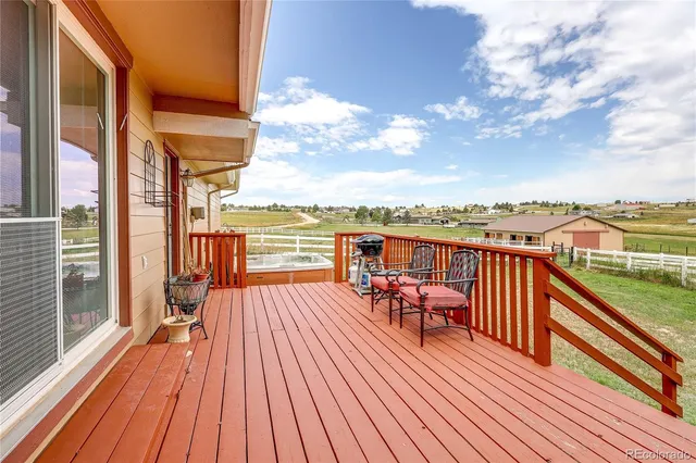 a view of a balcony with wooden floor