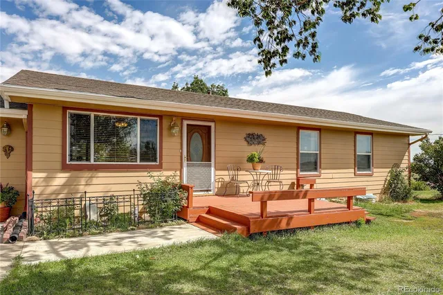 a view of a house with backyard sitting area and garden