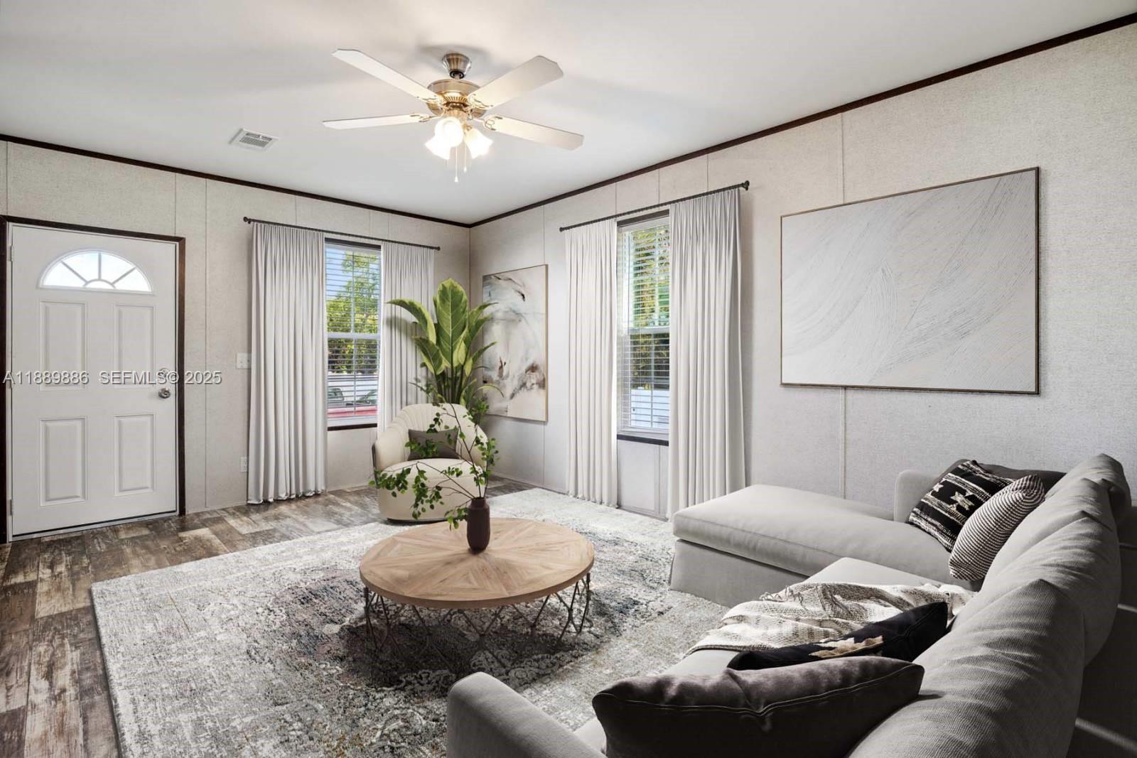 357 Horse Club Avenue Clewiston, FL 33440 - Photo 3 of 15 a living room with furniture and a potted plant