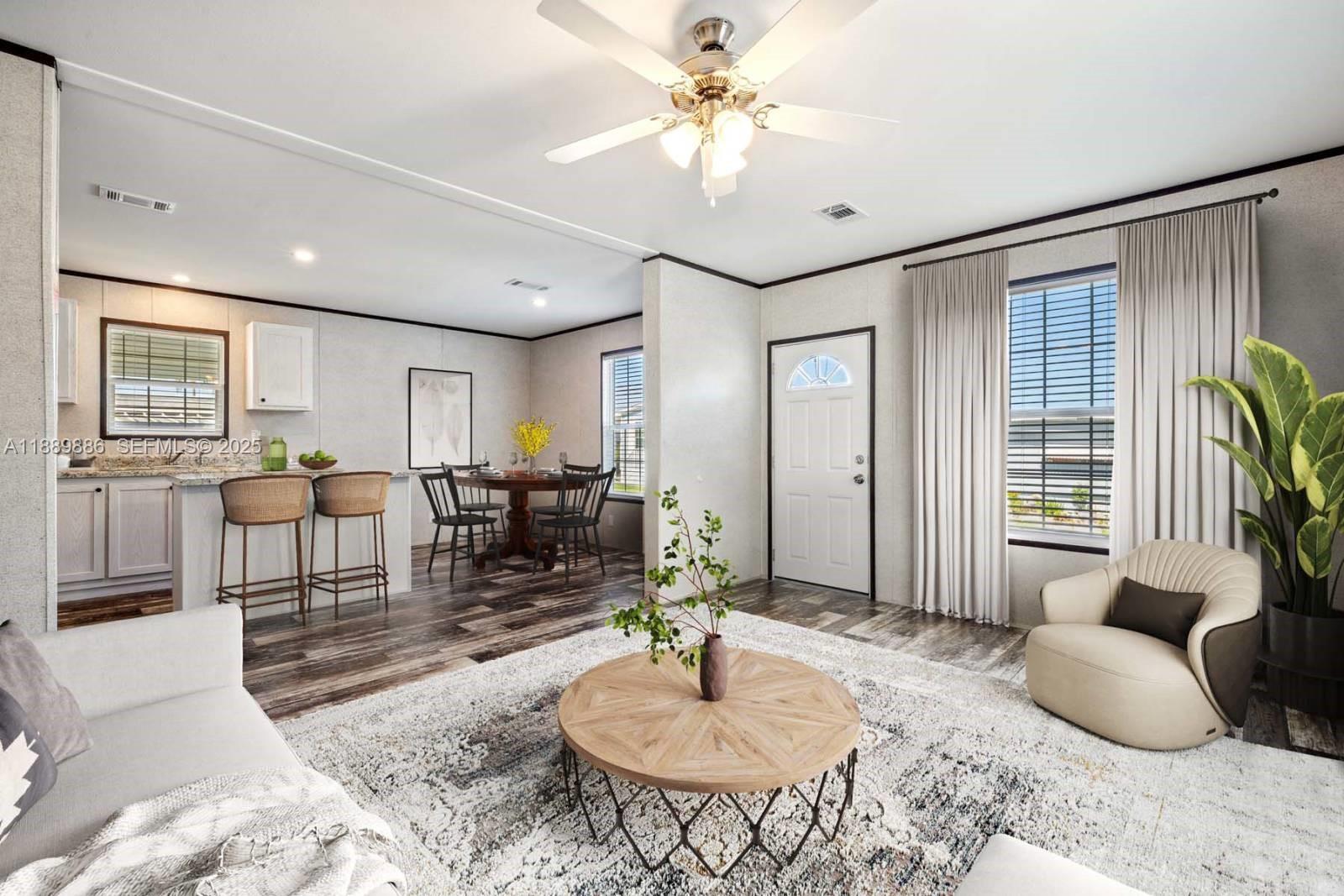 357 Horse Club Avenue Clewiston, FL 33440 - Photo 4 of 15 a living room with furniture a dining table and a chandelier