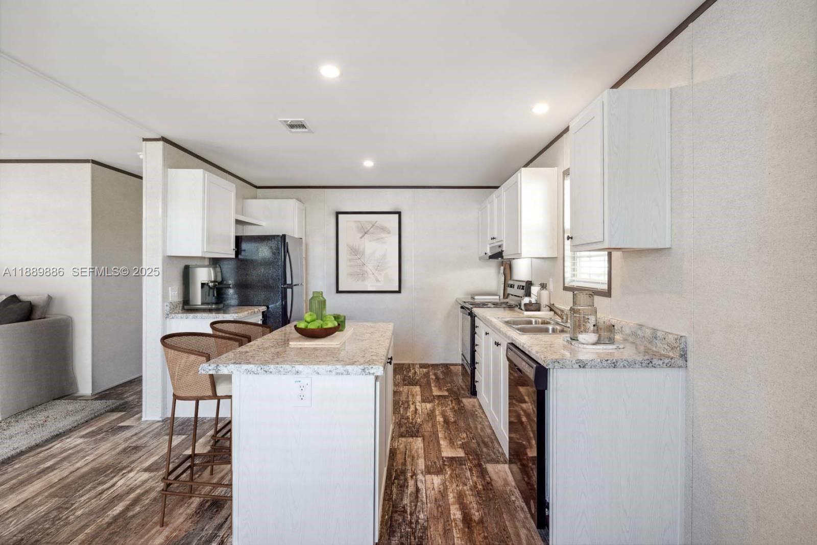 357 Horse Club Avenue Clewiston, FL 33440 - Photo 5 of 15 a kitchen with a sink stove and refrigerator