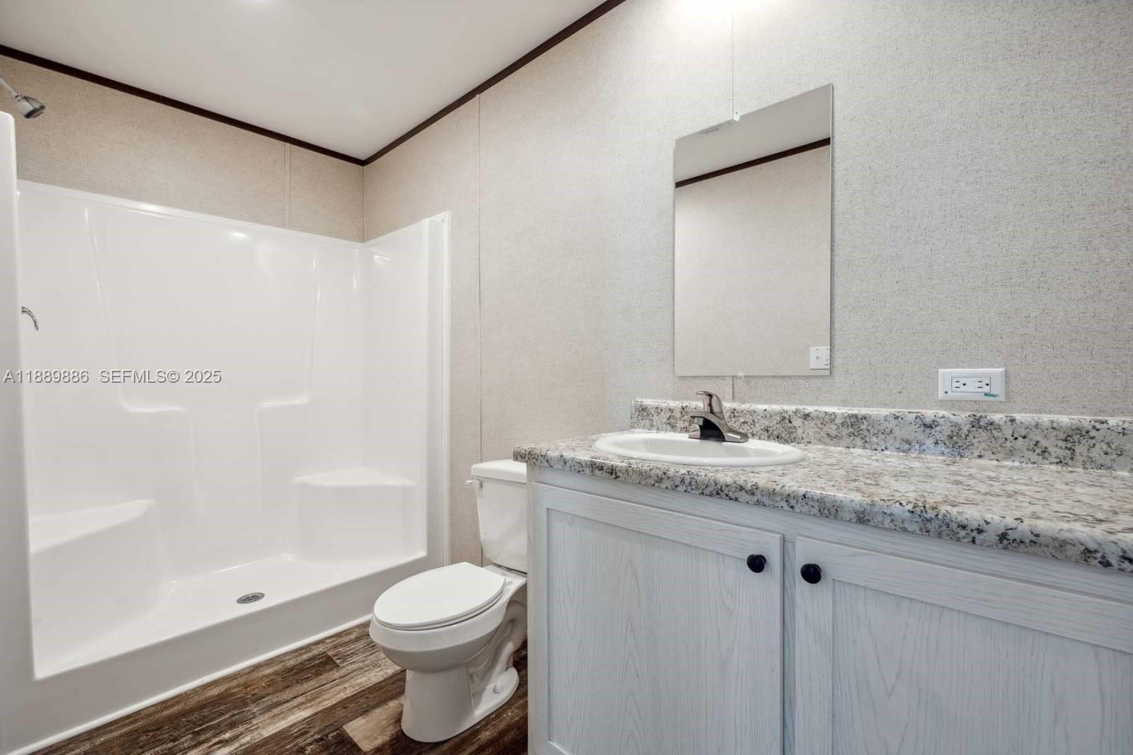 357 Horse Club Avenue Clewiston, FL 33440 - Photo 10 of 15 a bathroom with a granite countertop sink toilet and shower