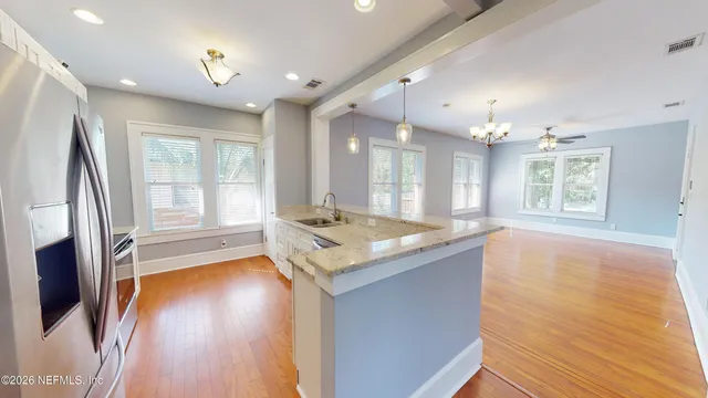 a spacious bathroom with a granite countertop sink and a large mirror