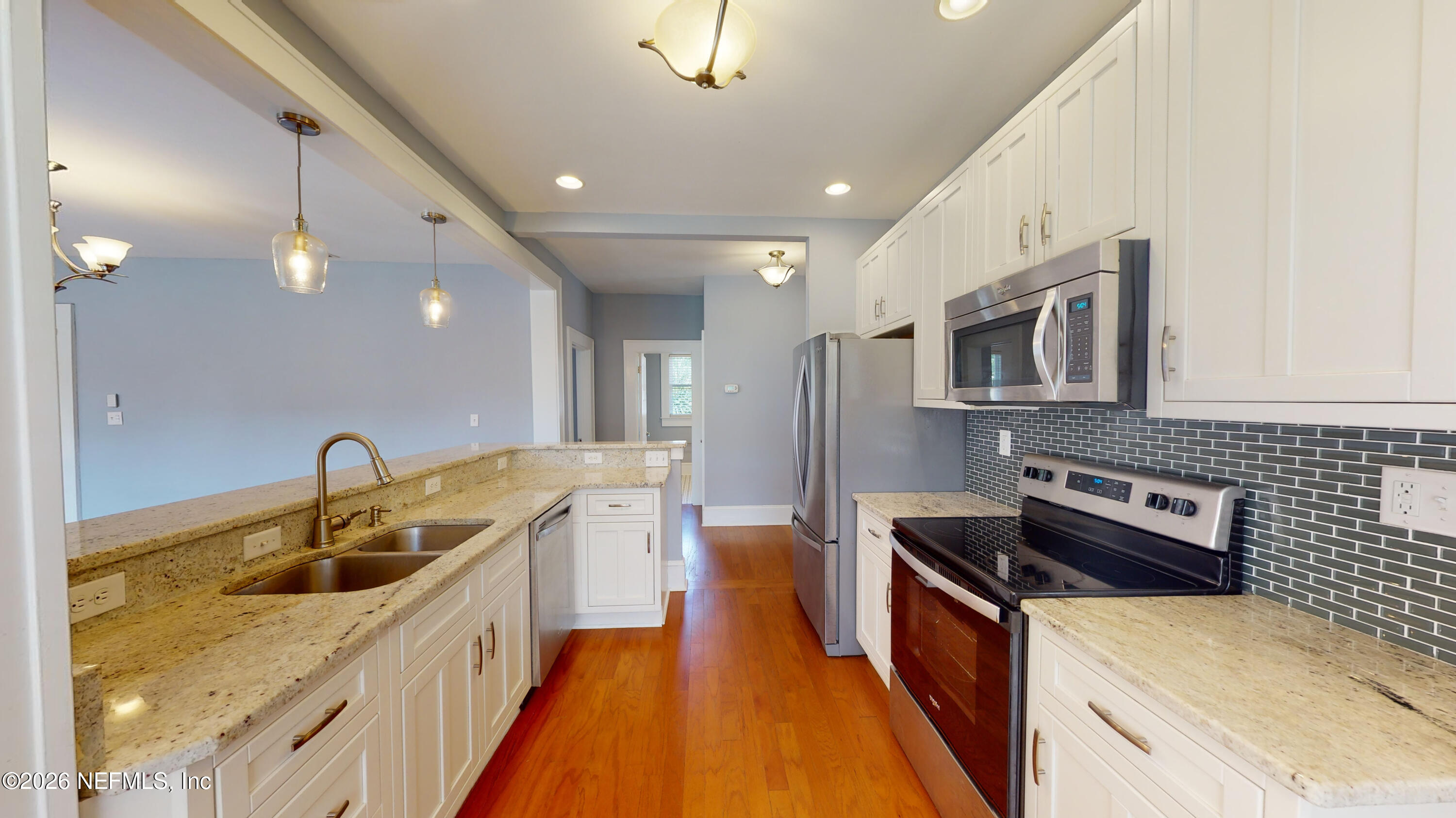1292 Wolfe Street Jacksonville, FL 32205 - Photo 14 of 27 a kitchen with kitchen island granite countertop a sink a counter top space stainless steel appliances and cabinets