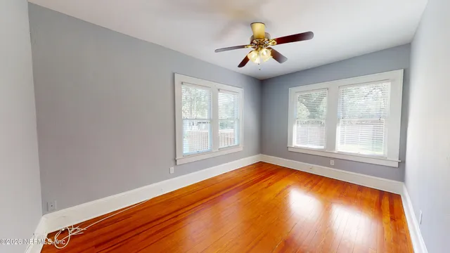 wooden floor in an empty room with a window