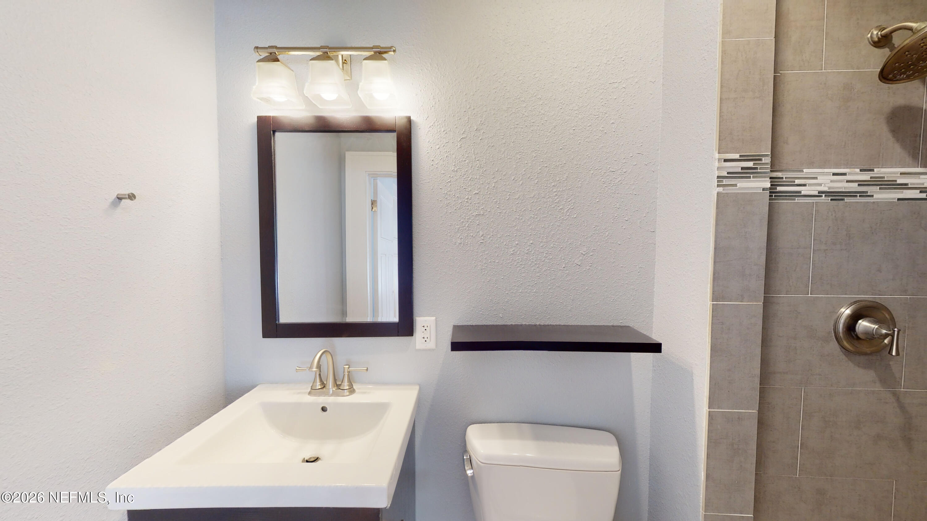 1292 Wolfe Street Jacksonville, FL 32205 - Photo 18 of 27 a bathroom with a toilet a sink and mirror