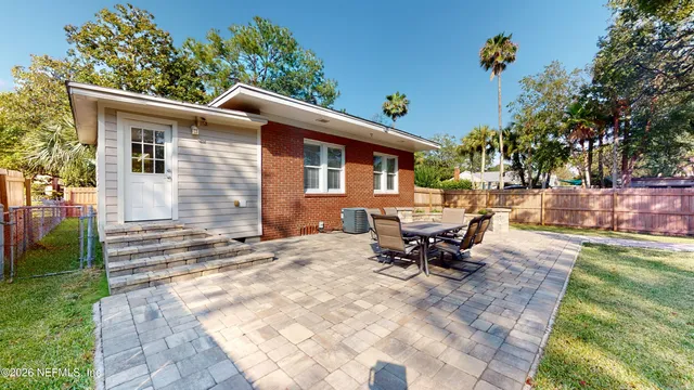 a backyard of a house with table and chairs