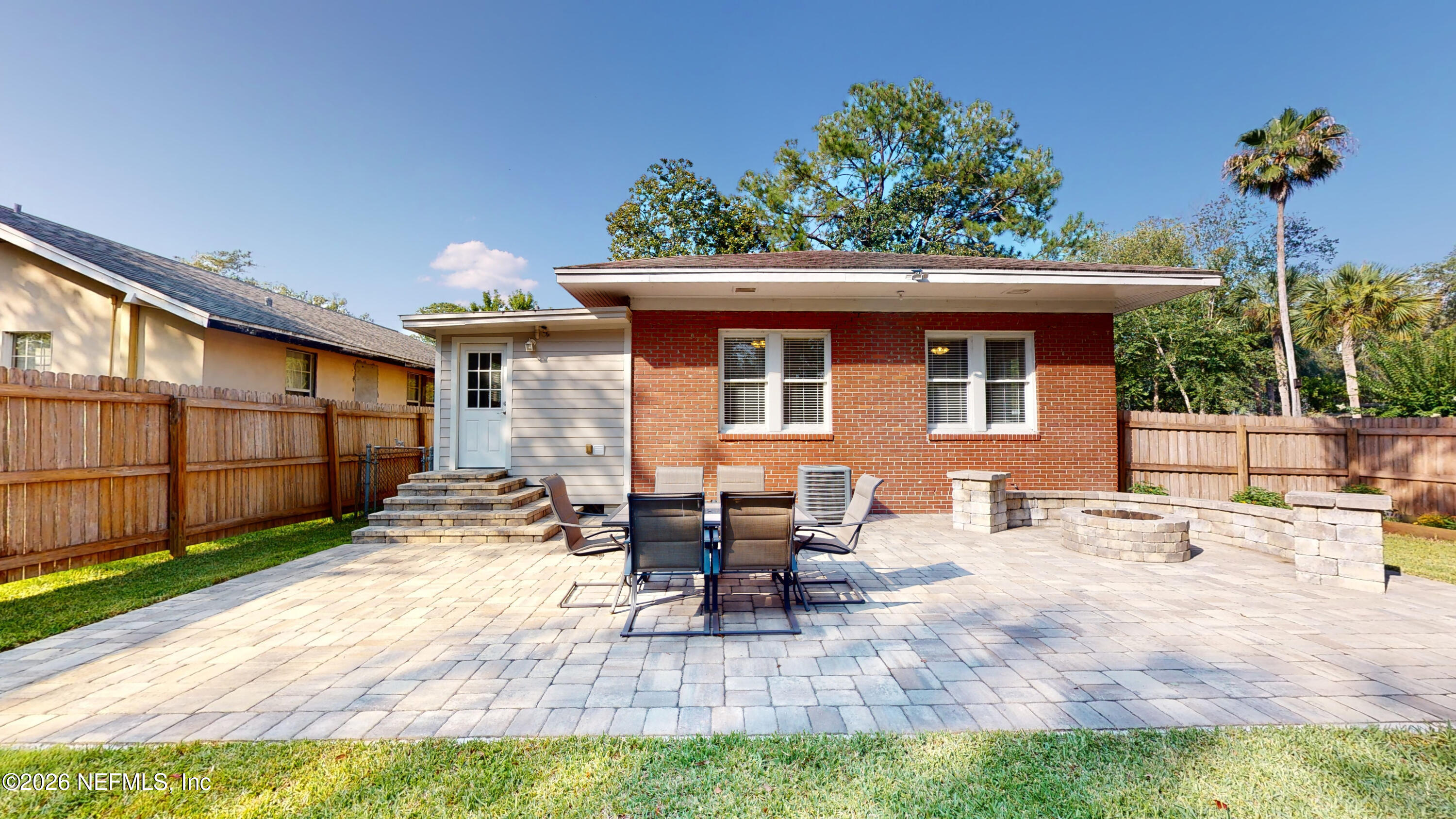 1292 Wolfe Street Jacksonville, FL 32205 - Photo 24 of 27 a view of a backyard with table and chairs potted plants and a small yard