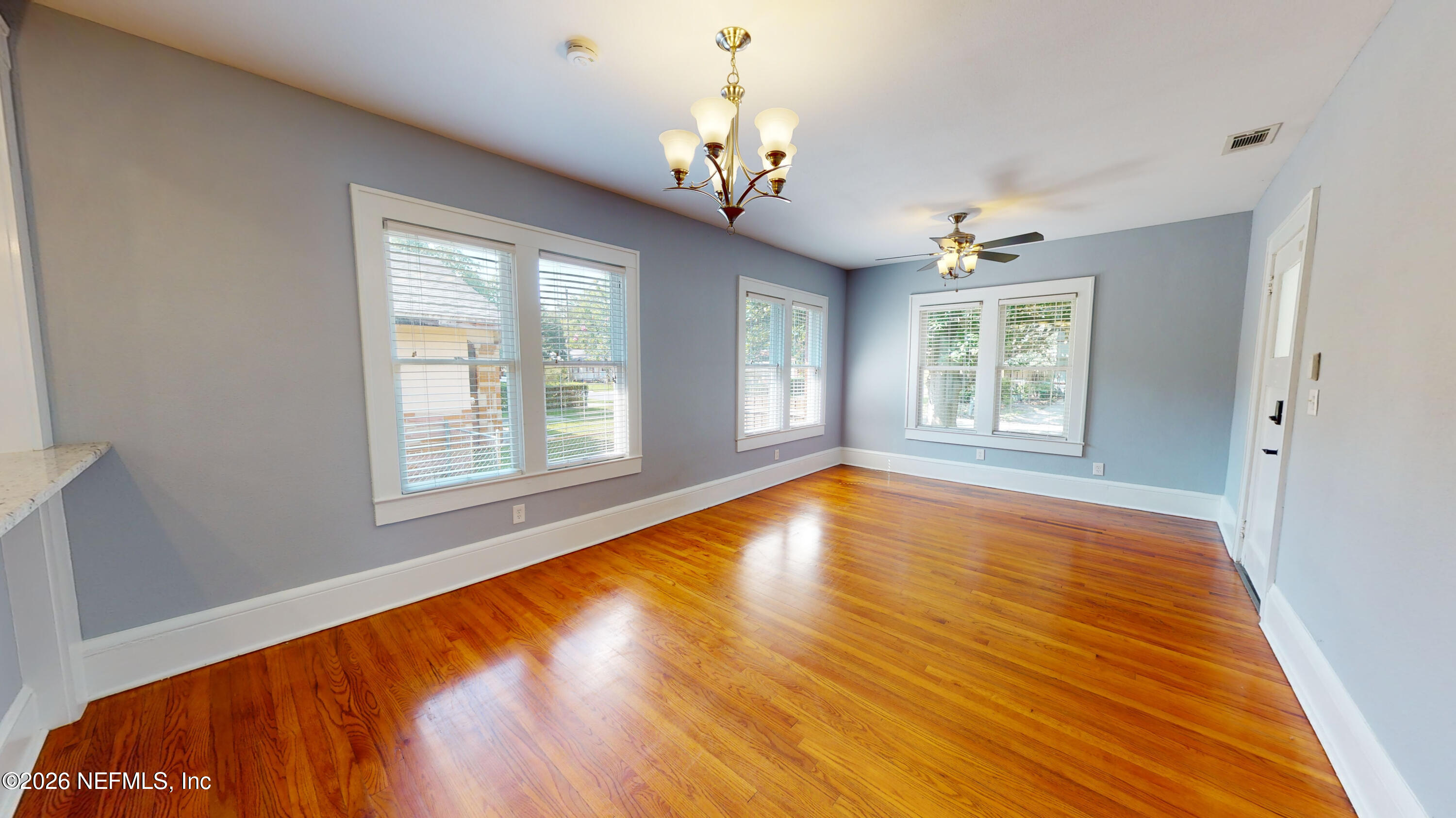 1292 Wolfe Street Jacksonville, FL 32205 - Photo 9 of 27 a view of an empty room with wooden floor and a window