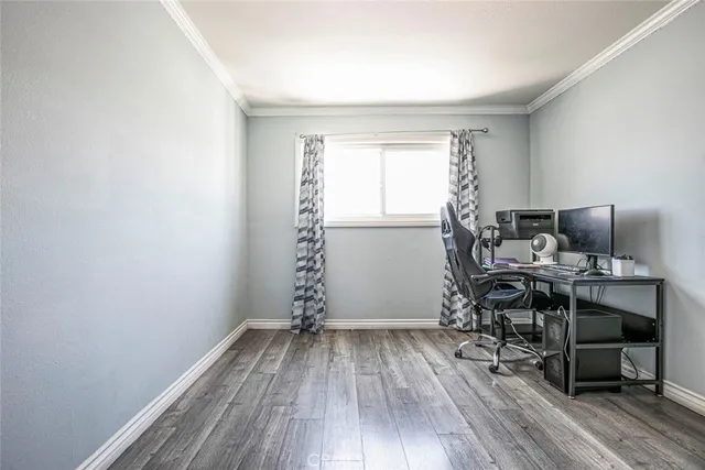 a view of a workspace with wooden floor