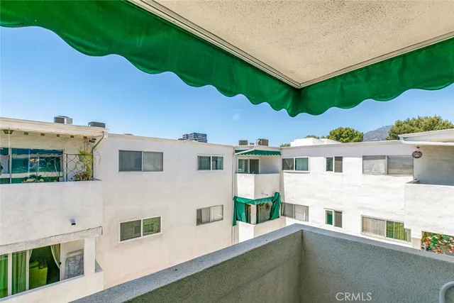a kitchen with cabinets and chairs