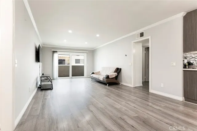 a room with wooden floor and window