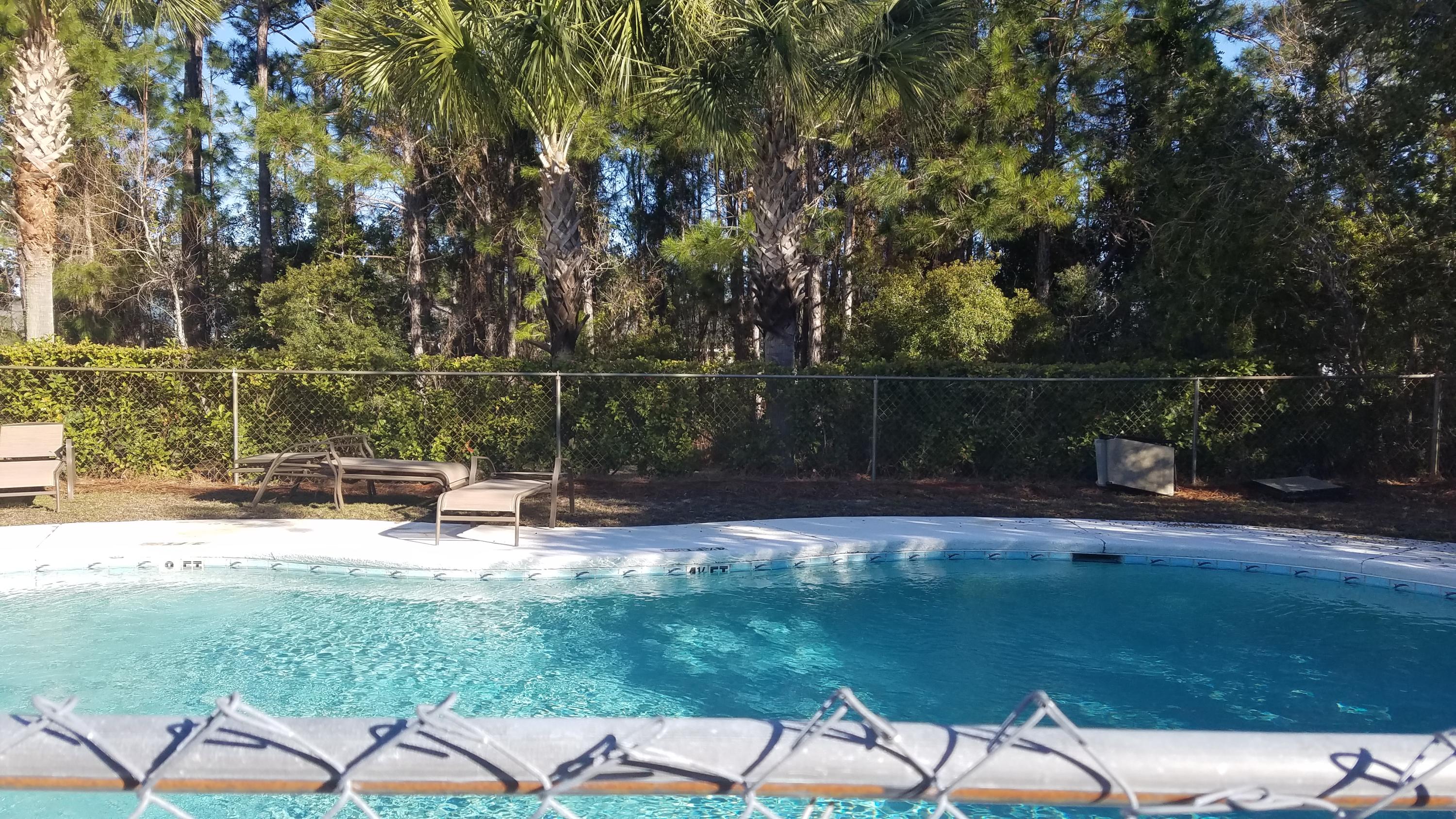 732 East Mack Bayou Drive, Unit 8 Santa Rosa Beach, FL 32459 - Photo 5 of 17 a backyard of a house with lots of green space