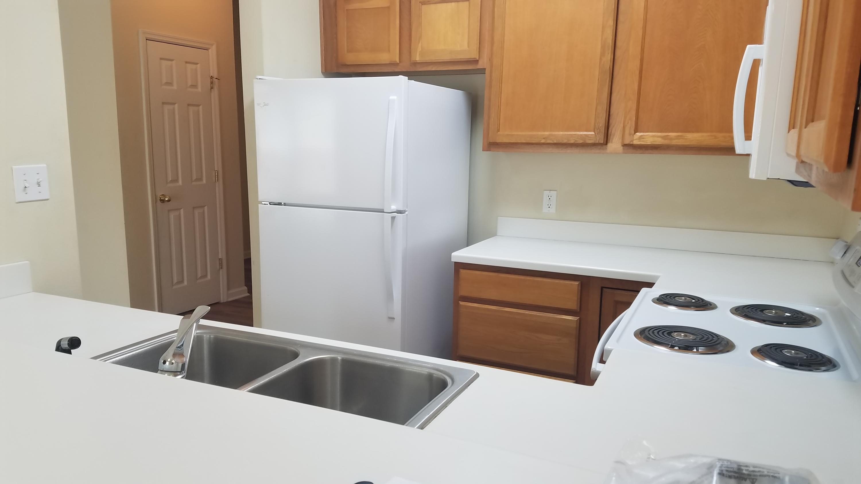 732 East Mack Bayou Drive, Unit 8 Santa Rosa Beach, FL 32459 - Photo 8 of 17 a kitchen with a refrigerator and a sink