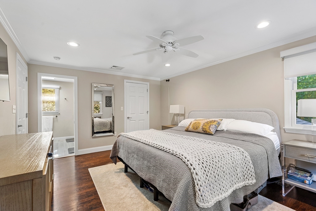 16 Cooke Road Lexington, MA 02420 - Photo 12 of 21 a bedroom with a large bed and a chandelier