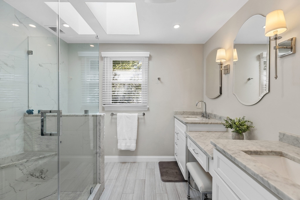 16 Cooke Road Lexington, MA 02420 - Photo 13 of 21 a bathroom with a granite countertop sink a toilet a mirror and shower