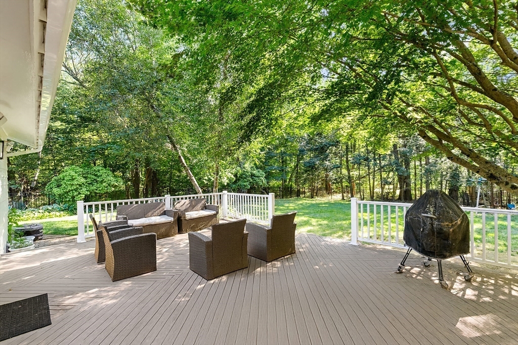 16 Cooke Road Lexington, MA 02420 - Photo 20 of 21 a view of a deck with table and chairs and wooden floor