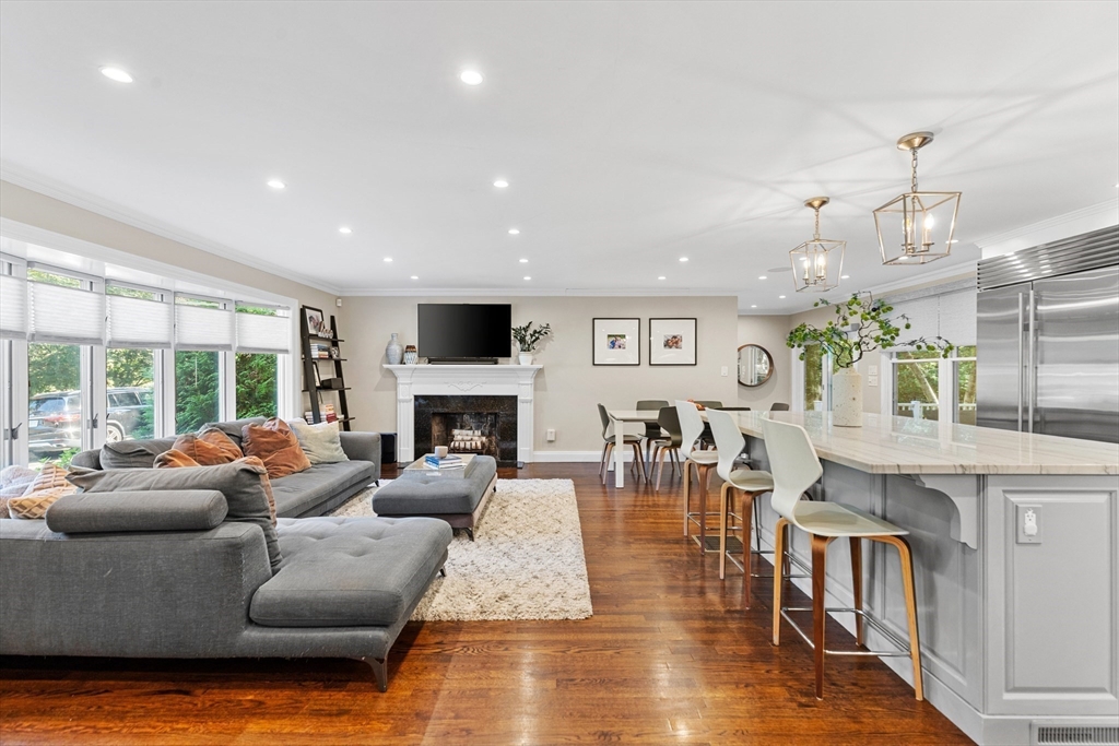 16 Cooke Road Lexington, MA 02420 - Photo 7 of 21 a living room with fireplace furniture and a wooden floor