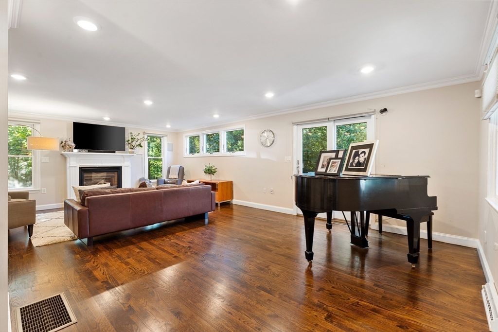 16 Cooke Road Lexington, MA 02420 - Photo 10 of 21 a living room with furniture a fireplace and a flat screen tv