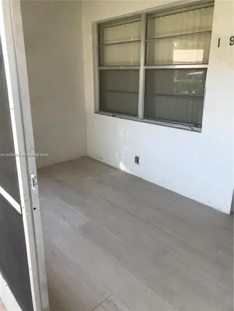 an empty room with closet and wooden floor